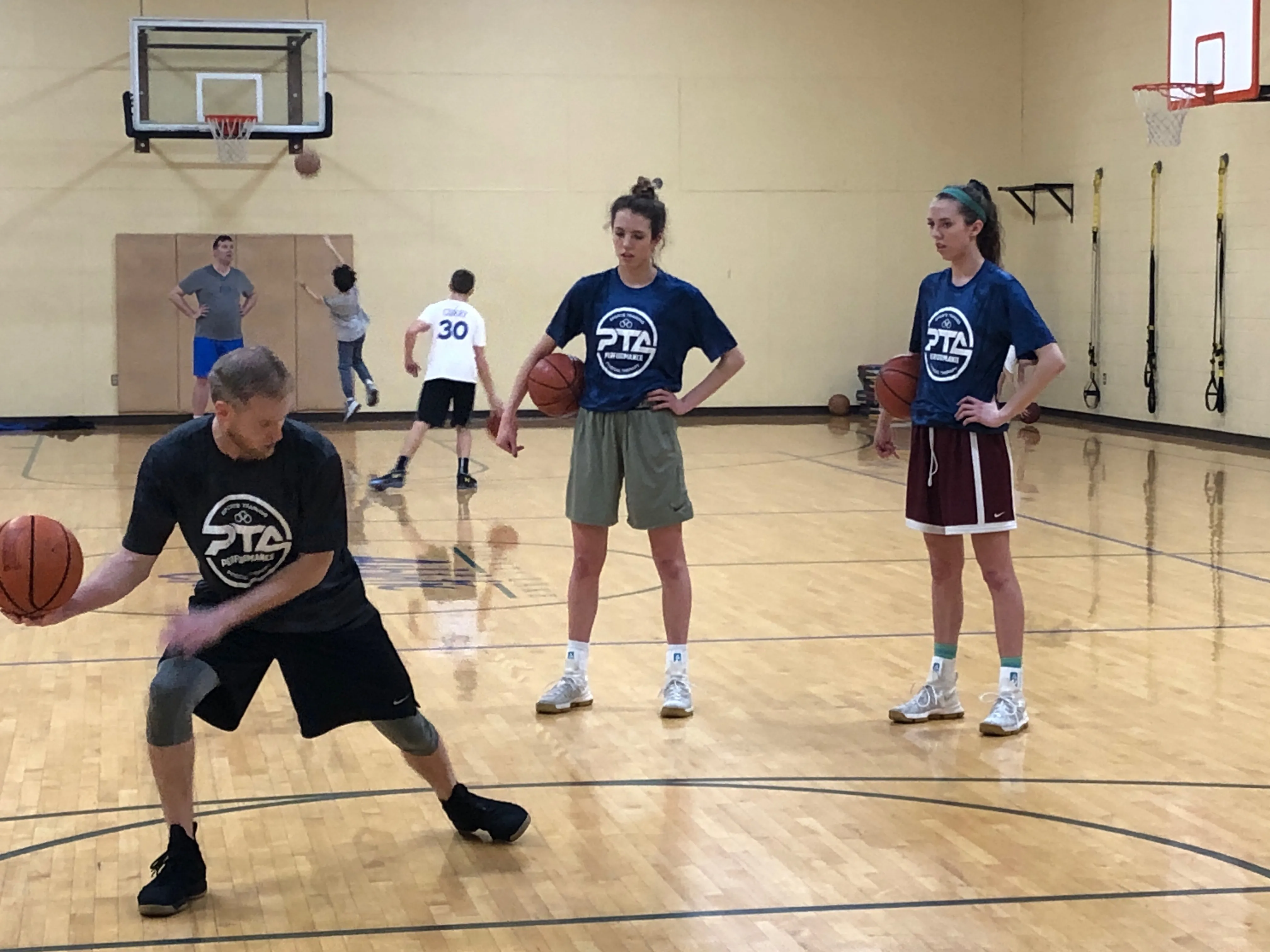 Eric demonstrates a basketball move to two players